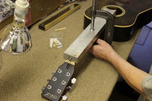 Lake Oswego, OR Luthier using heat press on fretboard